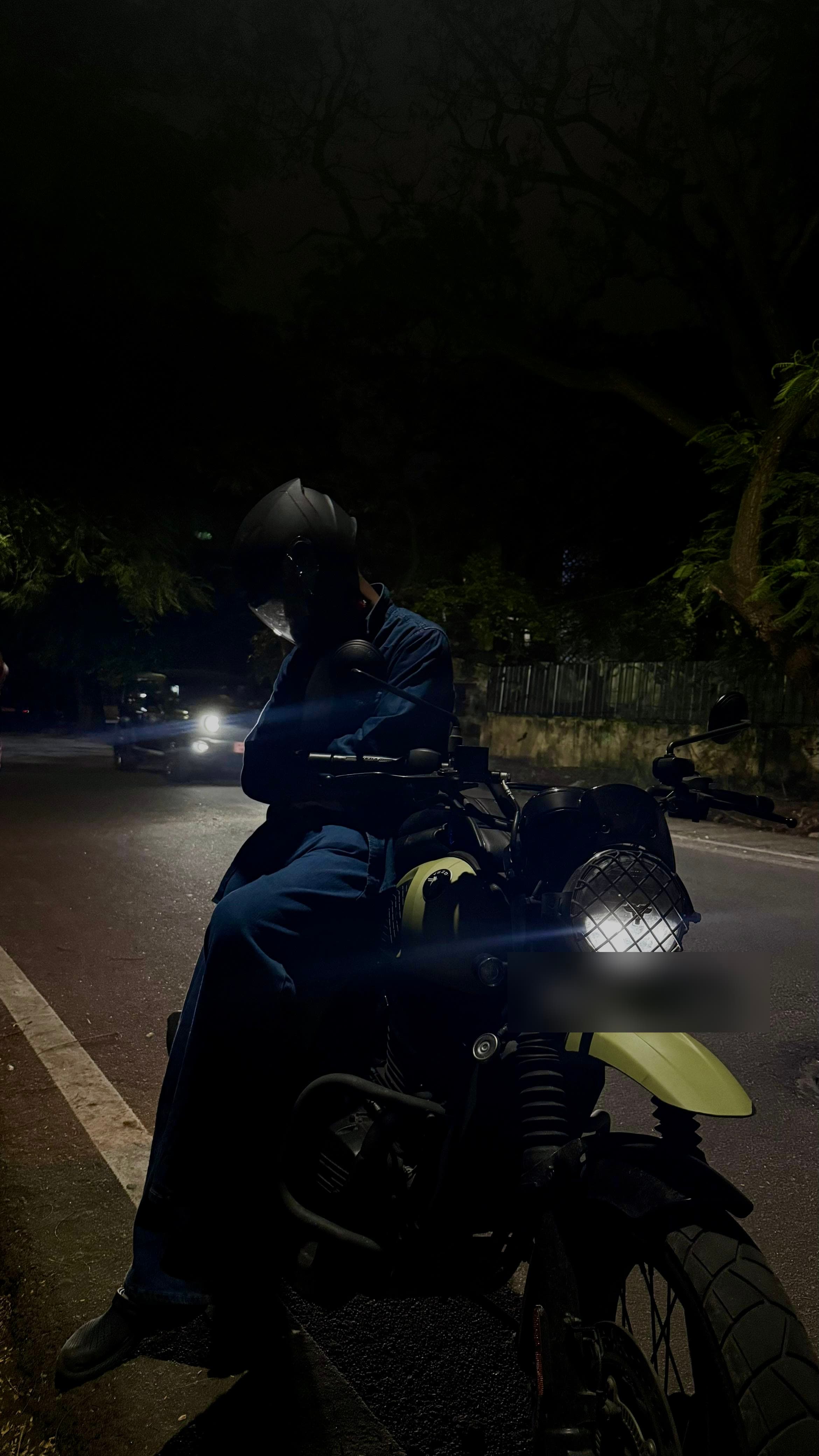 Sri sitting on a motorcycle during a night ride